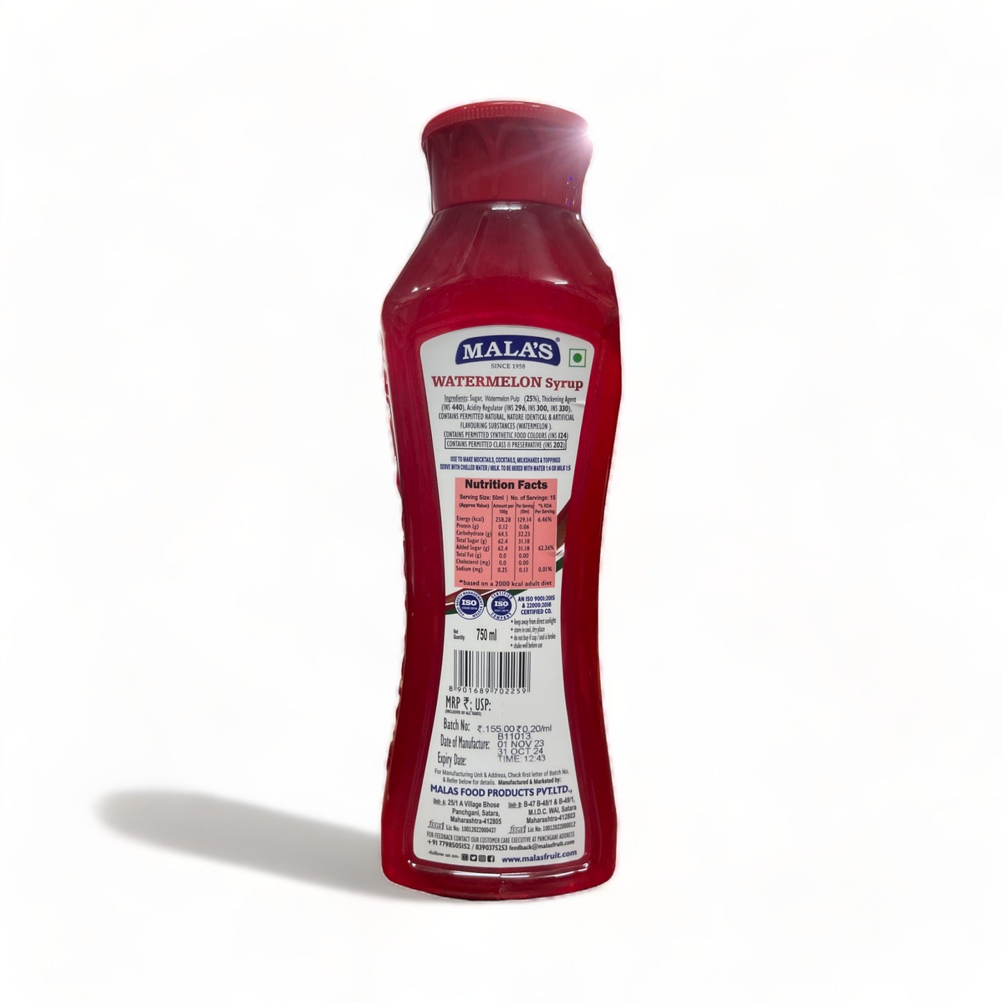 a red glass bottle sitting on top of a table